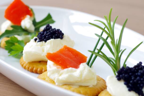 Crackers with salmon, caviar and cream cheese
