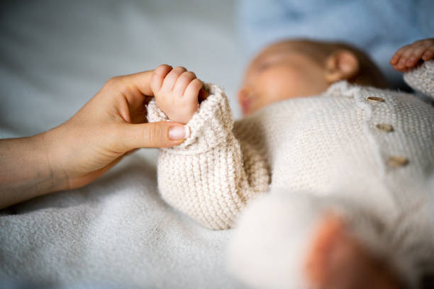 Baby sleeping in white bed. Healthy kids sleep. Little boy napping in parents bed. Sunny nursery for infant. Bedding for young child. Nap time. Toddler on sunny morning at home.