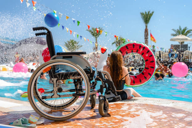 Disabled female by a swimming pool with  inflatable donut