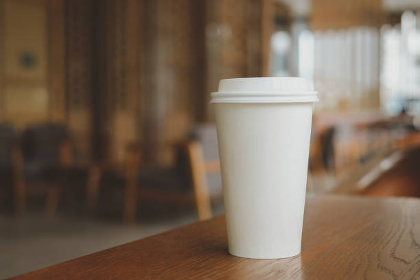 istock Coffee paper cup on wooden table. Take away hot drink. 1408428538