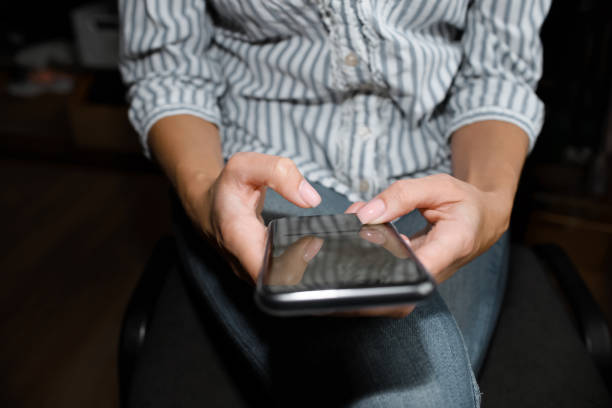 istock Woman is using the phone. Touches the smartphone screen. Close-up, selective focus. Cropped 1408429048