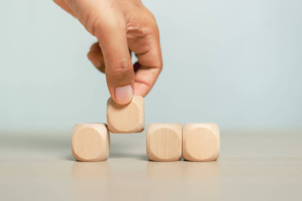 istock Concept of education and development. Hand picking blank wooden cube block sort on table use for create text or symbol. growth success. 1408433301