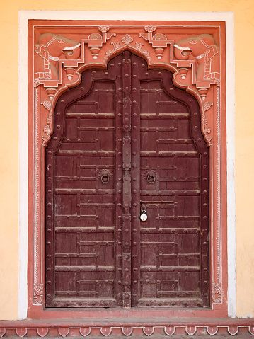 Wooden gate of art work Door in City Palace Jaipur,Rajasthan, India.