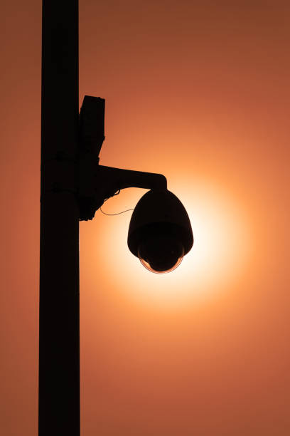 istock Street surveillance camera on a white metal pole 1408434881