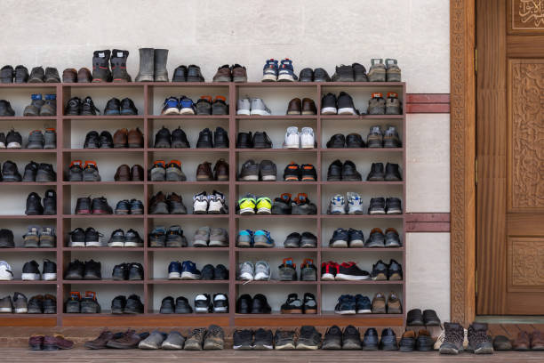 Shoes of people praying in front of the mosque, shoe rack stock photo