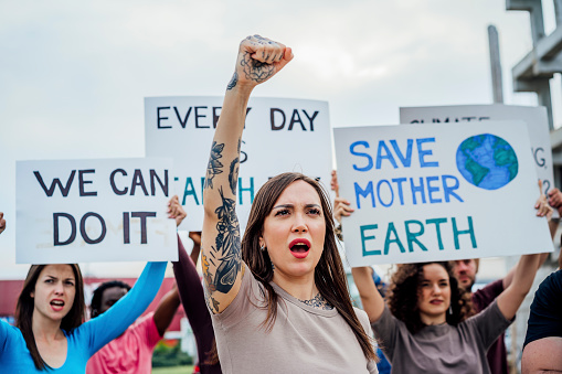 Group of young people with banners protesting against climate change