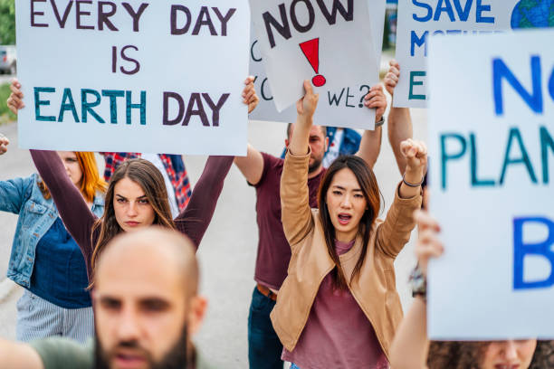 istock Group of people marching against climate change 1408444231