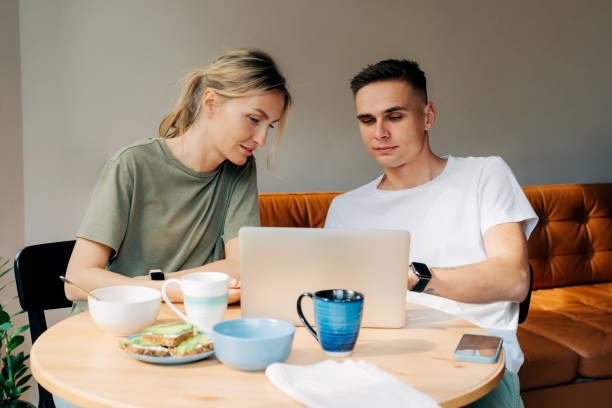 istock At a family breakfast, a man uses a laptop for work 1408444913