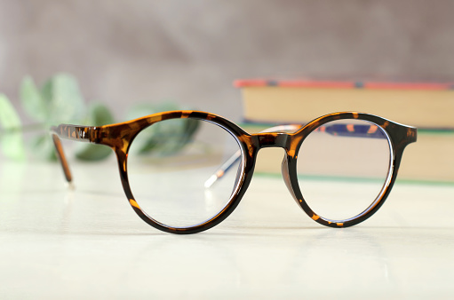 Stylish eyeglasses in leopard color on the desk.