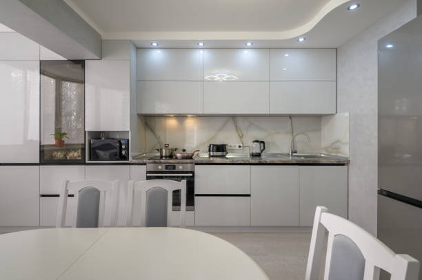 istock Interior of modern trendy white kitchen, front view 1408448267