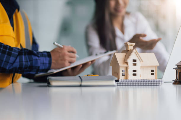 istock Female architect designers in the office work with contractor engineers modeling houses and writing housing projects. 1408448978