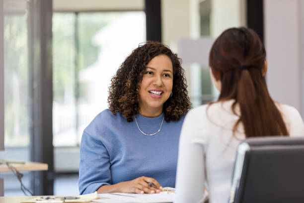 istock Female co-workers meet to brainstorm ideas for presentation 1408450528