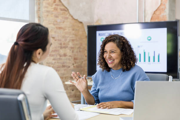istock Female co-workers enjoy meeting together 1408450659