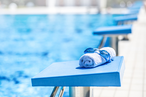 Poolside and blue water of pool. With copy space