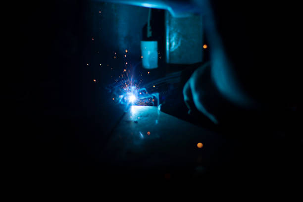 Steel welding. Metal processing. Welder makes welding seam. Details of production of metal structures.