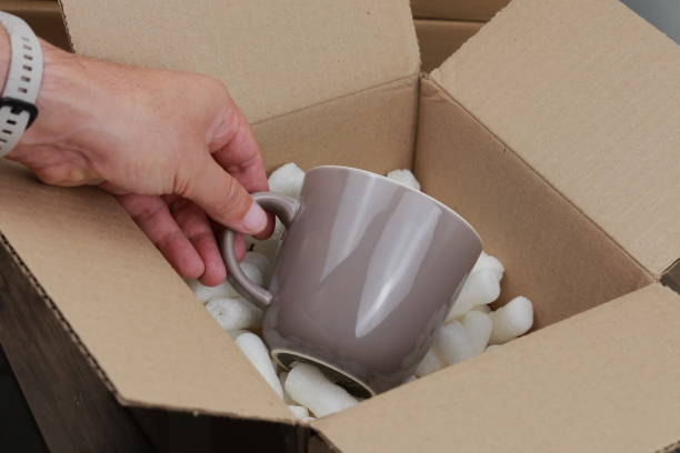 istock A mug is put in a cardboard box with polystyrene to protect it during transport. 1408451618