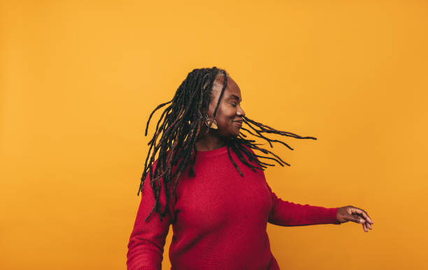 istock Joyful black woman whipping her dreadlocks in a studio 1408451710