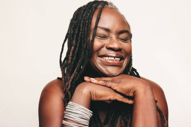 istock Happy woman with dreadlocks smiling cheerfully in a studio 1408451727