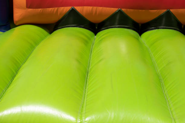 istock Inflatable trampoline. Amusement park. Green rubber. 1408453482