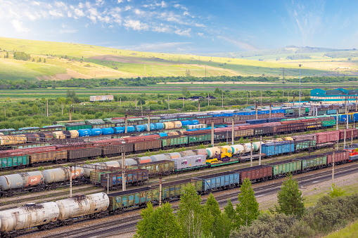 Krasnoyarsk, Russia - June 23, 2022: Freight wagons in sorting station of railway. Dead end on railway station with cargo wagons, cisterns and open platforms.