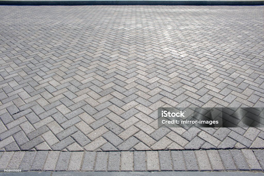 white and grey harring patterned brick floor pavement outdoors Textured chevron background pattern herringbone brick tile floor walkway or patio Herringbone Stock Photo