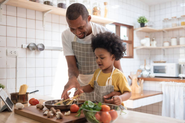 istock African Father teaching his son cooking 1408455293