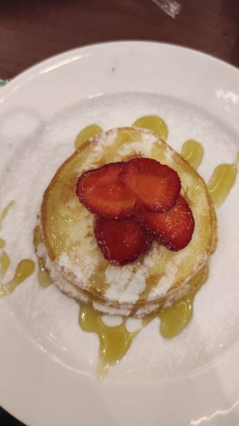 istock Pancake with honey, sugar and strawberry 1408455758
