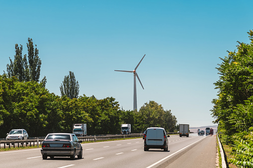 Clean energy wind turbine installed next to the highway
