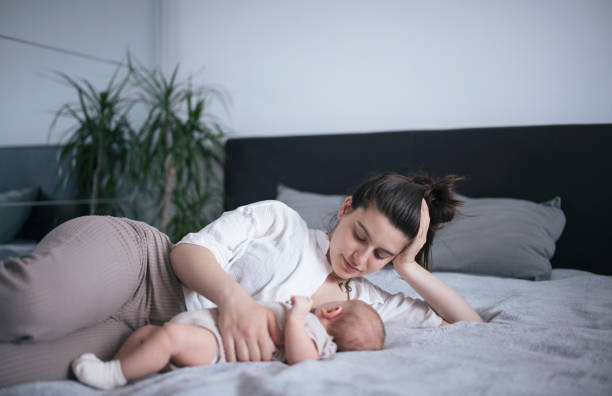istock Mother breastfeeding laying down. 1408460010