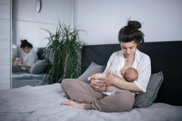 istock Young mother breastfeeding baby. 1408460031