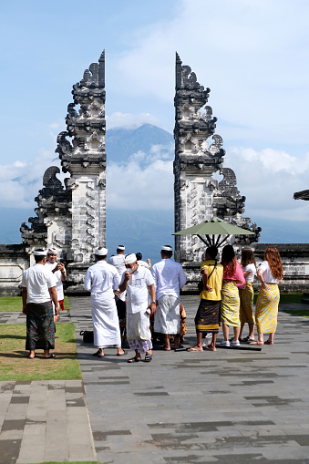 Local people wearing sarong at the gate of heaven in the Pura Lempuyang, a Hindu temple located in the slope of Mount Lempuyang in Karangasem. It is one of the highly regarded temples of Bali.