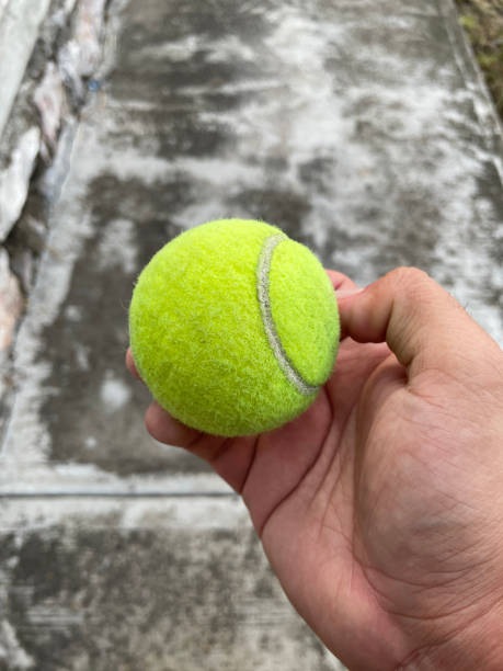 istock A hand holds a green tennis ball 1408465534