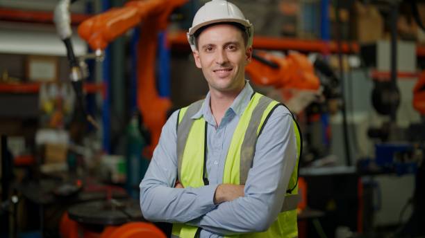 istock Engineer portrait, Portrait Manager engineer working with Robotic arms in factory. Engineer programming robotic operate production line manufacturing. 1408466024