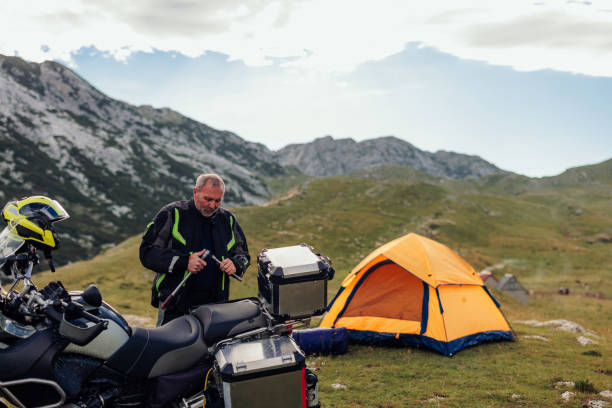 istock Male biker unloading his luggage 1408467673