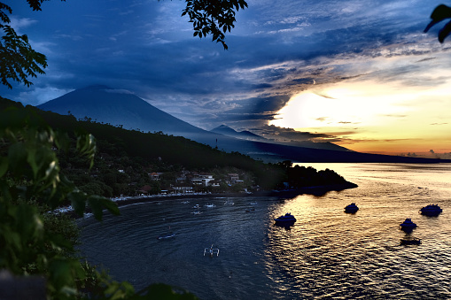 View of Amed coast and mount Agung at sunset, an active volcano and the highest point on Bali at 3031 mt.
