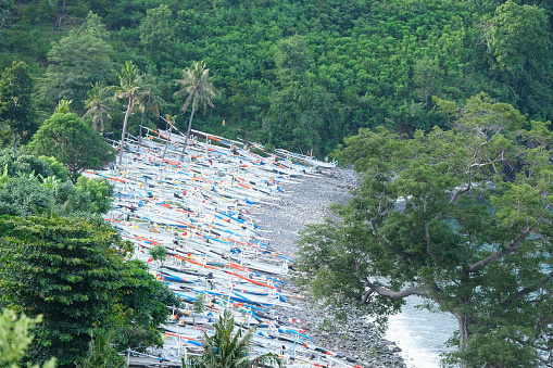 Outriggers moored on a Black sand beach on Amed coastline, Bali, Indonesia