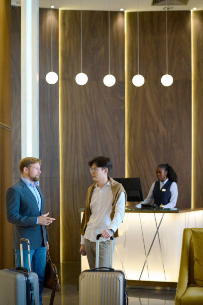 istock Two elegant businessmen with baggage discussing working points of travel 1408468625