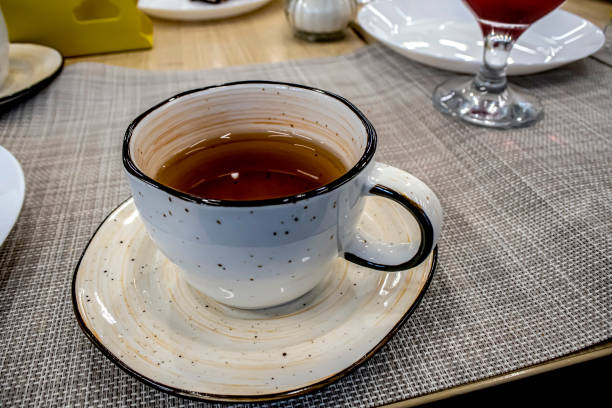 istock mug with hot tea on the table 1408468692