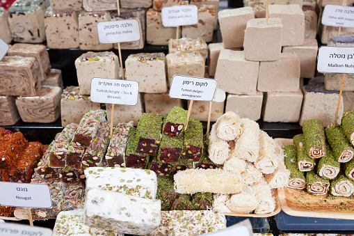 A variety of turkish delight sweets, rolled in almonds and pistachios, on display at Carmel Market, Tel Aviv