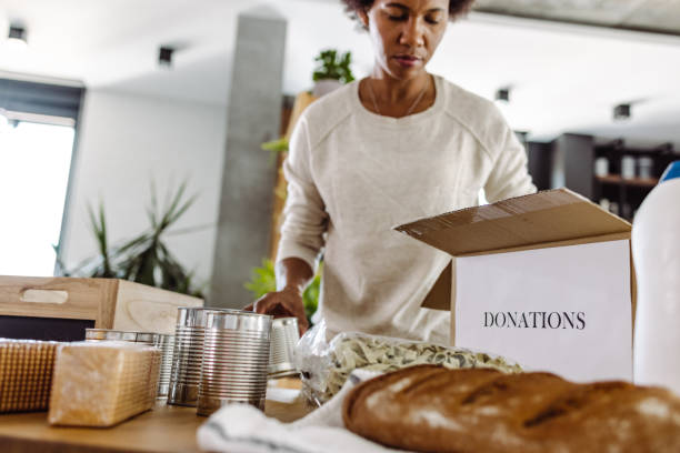 istock Packing and preparing donations for charity organization 1408470013