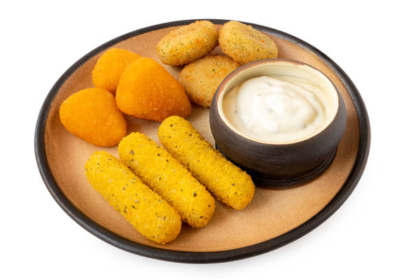 istock Fried breaded brie and camembert nuggets and mozzarella sticks on a rustic ceramic plate with white dip on white. 1408470228