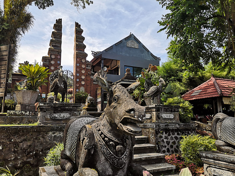 Statues at the magnificent Tirta Gangga, a former royal palace in eastern Bali, Indonesia. Named after the sacred river Ganges in Hinduism, it is noted for the water palace, bathing pools and its Patirthan temple.\nIndonesia