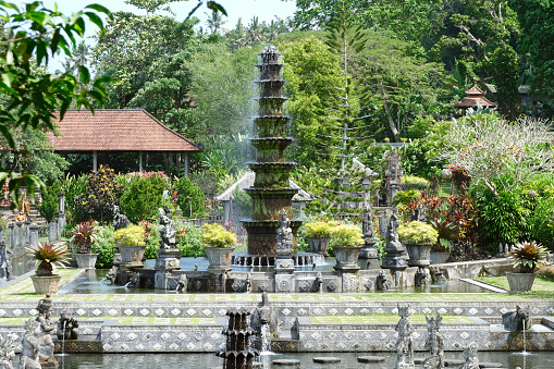 Fountain at the magnificent Tirta Gangga, a former royal palace in eastern Bali, Indonesia. Named after the sacred river Ganges in Hinduism, it is noted for the water palace, bathing pools and its Patirthan temple.\nIndonesia