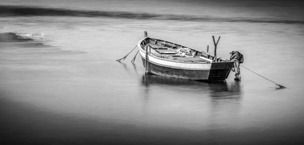 istock ANCHORED BOAT IN GALICIA, black and white 1408476988