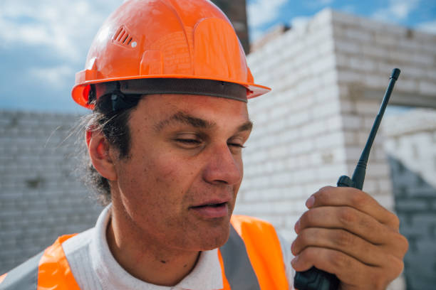 istock Construction worker in the helmet speaks on the radio 1408478899