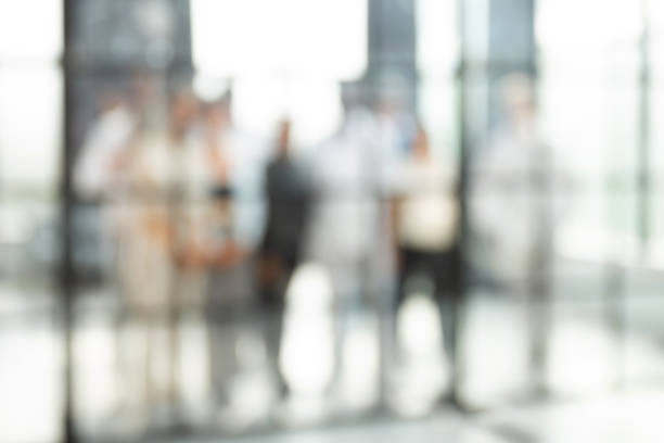 istock Blurred image of business people standing in the office 1408480404