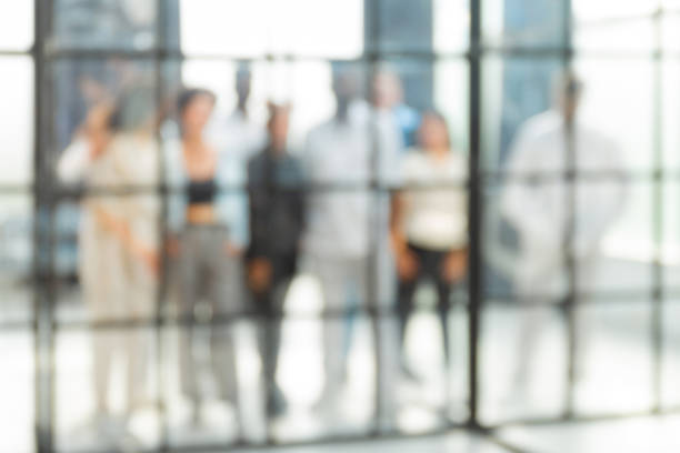 istock Blurred image of business people standing in the office 1408480572