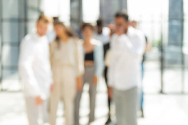 istock Blurred image of business people standing in the office 1408480606
