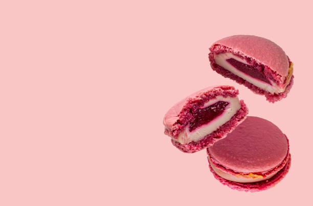 istock macaroons with fruit filling on pink background, selective focus, copy of space 1408480651