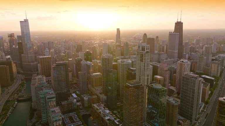 Tremendous skyscrapers in the light of downing sun. Stunning city panorama and hazy skyline in the rays of sunset. Top view.